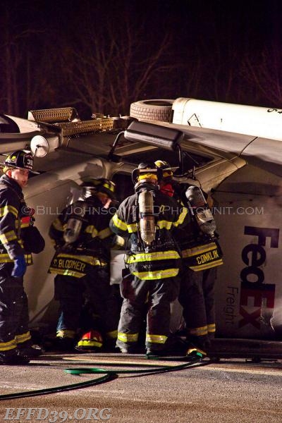 Members work on rolled over tractor trailer  
