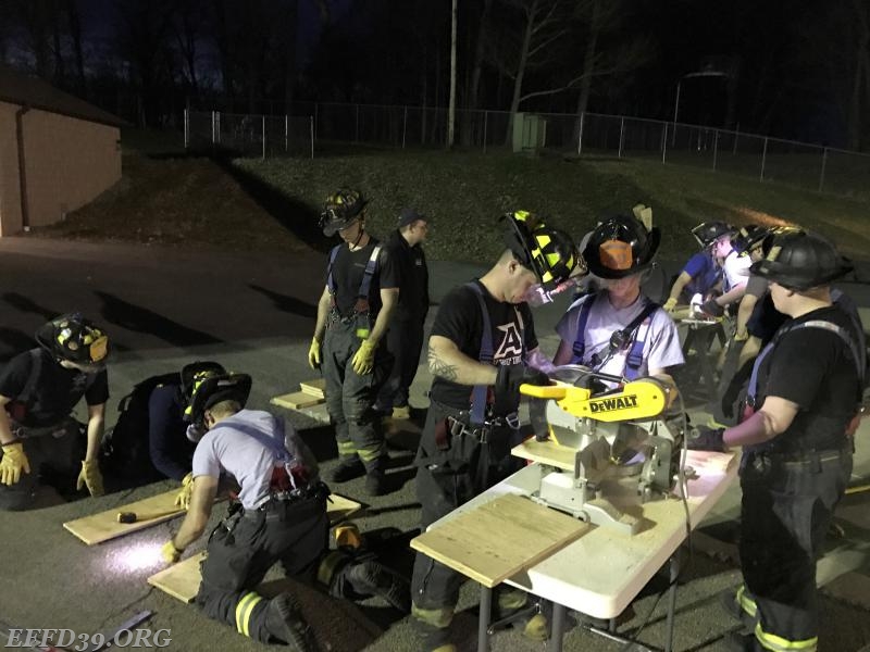 Members working on building shoring for drill.